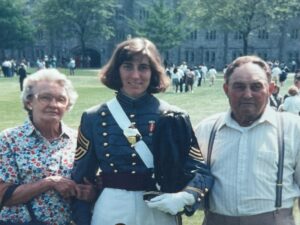 three people at army graduation