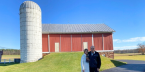 couple in front of red barn