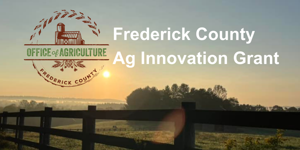 Fence with sunset Office of Ag logo, Frederick County Ag Innovation Grant text