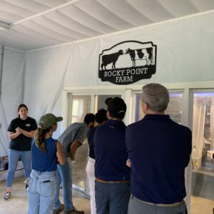 group of people getting a tour in a dairy barn