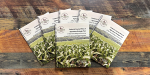 Wood background with copies of Frederick County Agriculture Strategic Plan