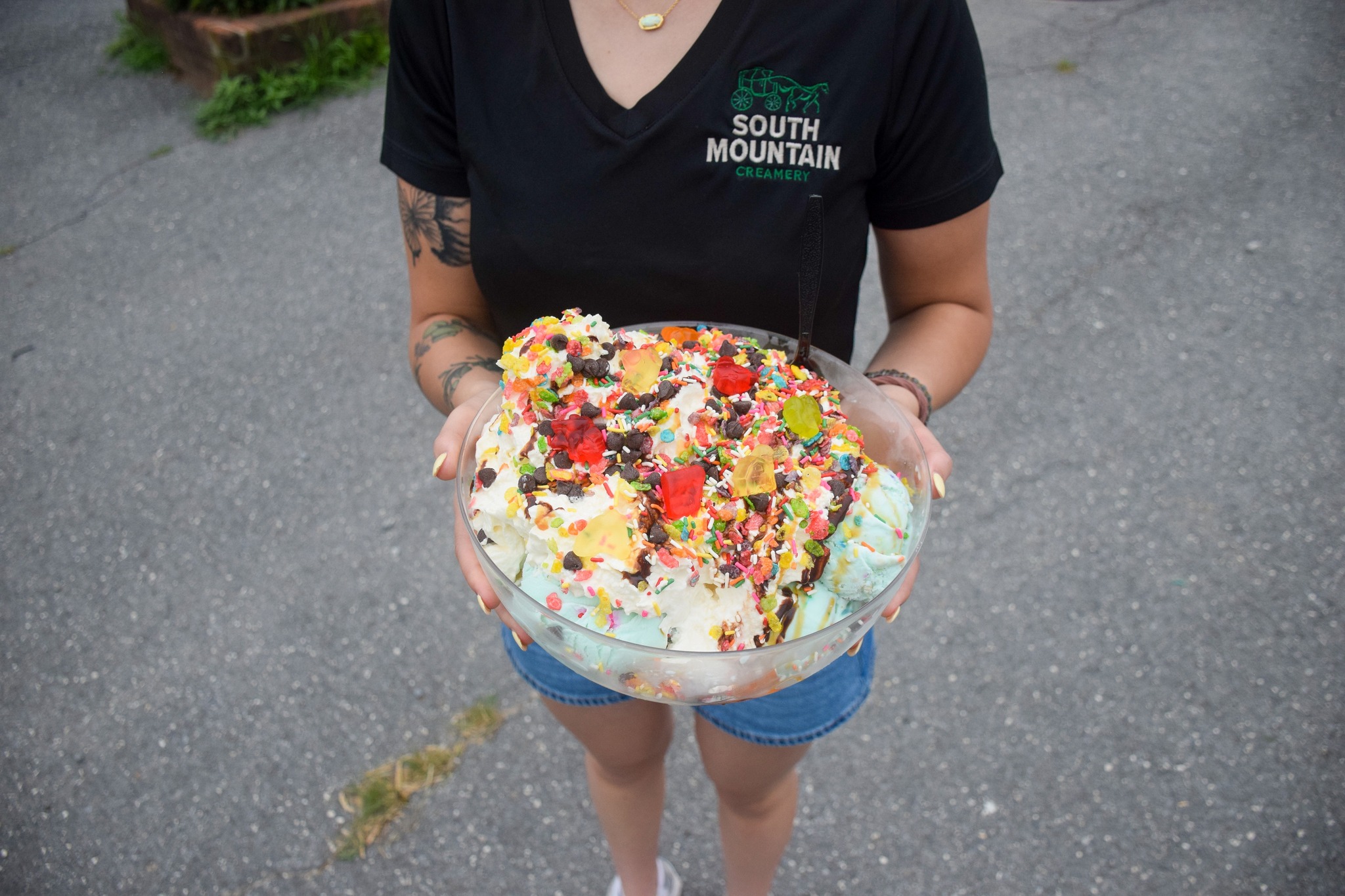 smc sundae person holding large ice cream sundae with a variety of toppings