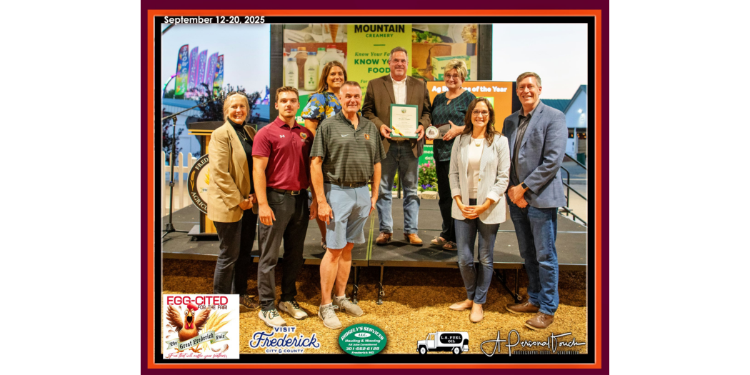 man and woman receiving an award on stage