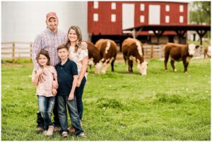 famiy with barn and beef cattle in the background