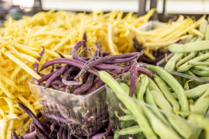 baskets of purple, green and yellow beans