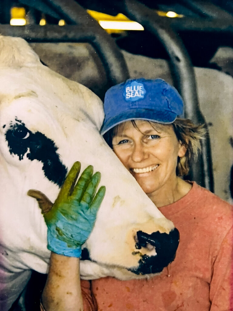 a women and a cow looking to the camera