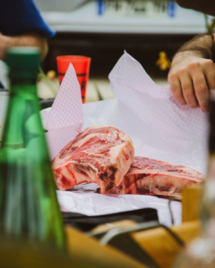 a slice of meat being wrapped up